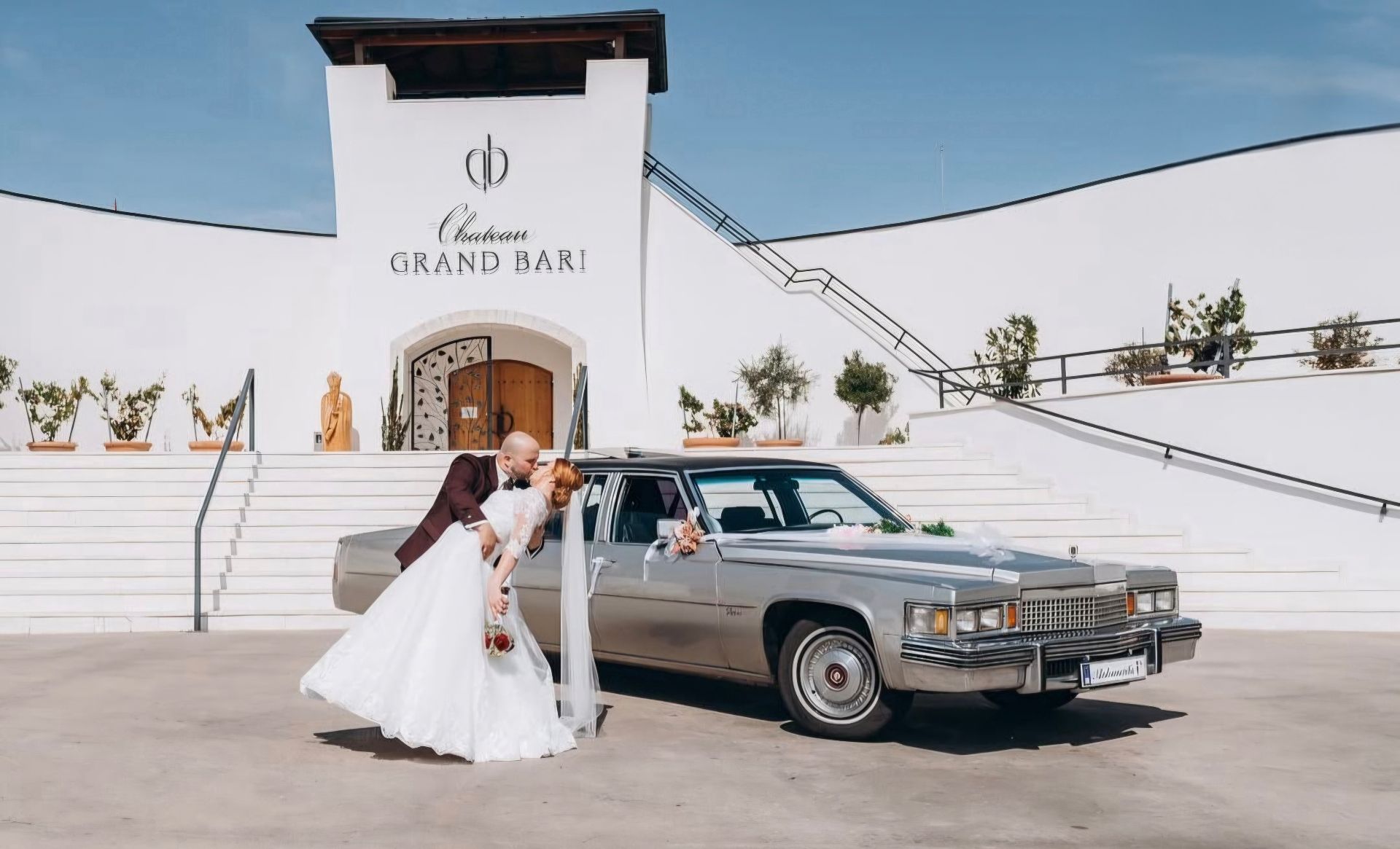 Bozk novomanželov pri Cadillacu Fleetwood pred Chateau Grand Bari